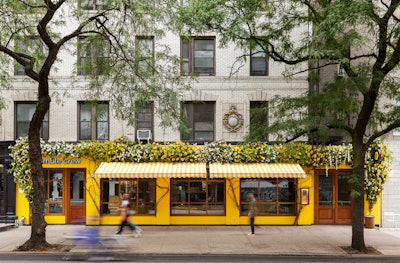 The space’s yellow facade and overarching floral installation by Floratorium serve as an anchoring brand moment for Bumble.