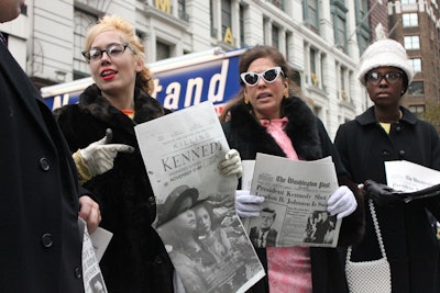 Near the stand, brand ambassadors dressed in '60s-era garb buzzed excitedly about the big news; they also passed out copies of the front page of The Washington Post and The New York Times from Nov. 23—which included black-and-white Killing Kennedy promotional ads—as well as JFK half-dollar coins in cases inscribed with information about the premiere. See more: National Geographic Brings News of Kennedy's Death to the Streets