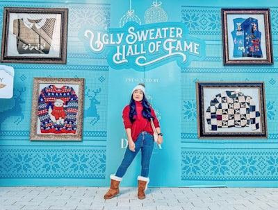 Another space, the 'Ugly Sweater Hall of Fame,' is a 40-foot gallery wall with framed ugly holiday sweaters. It also includes an oversized frame and selfie station for consumers to capture their own 'ugly' attire.