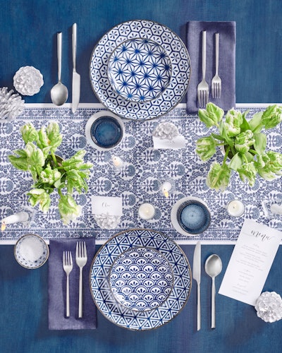 Brooklyn-based entertaining company Social Studies’ True Blue ensemble ($42 per place setting) features a timeless combo of blue and white prints with navy napkins, textured blue glasses, classic silver flatware and white votives.
