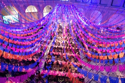 Look up! The ceiling can be an overlooked spot for interesting decor, too. For the Brooklyn Museum’s annual fundraising gala in 2019, David Stark Design and Production opted for a Frida Kahlo theme, inspired by the museum’s then-new exhibition “Frida Kahlo: Appearances Can Be Deceiving.” The ceiling of the museum’s Beaux-Arts Court featured a cascade of colorful “papel picado” decorations.