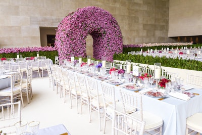 For dinner, Met Gala guests entered the Temple of Dendur through an arched doorway in a 70-by-20-by-10-foot wall made of 300,000 additional roses. Dinner tables featured red, burgundy and lavender florals, and custom-printed chargers had a deconstructed rose pattern. Raul Avila handled design and production. See more: See How Tech and Fashion Mixed at the Met Gala