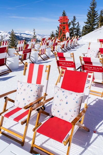 Each of the 72 seats at Snow Beach have an embroidered pillow featuring one of Gray Malin's signature aerial beach prints.