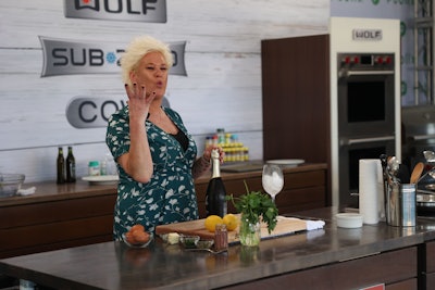 An enthusiastic Anne Burrell worked the audience while popping a bottle of bubbly for her Grand Tasting cooking demo.
