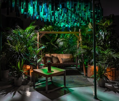 Inspired by A Midsummer Night’s Dream, this immersive swing installation, by Carl Hansen & Søn with design by Rockwell Group, provided guests with a relaxing space that was outfitted with green mirrors, reflective surfaces and lighting that cast shadows and bounced light. Suspended green plexiglass pieces fluttered overhead, creating a twinkling disco ball effect.