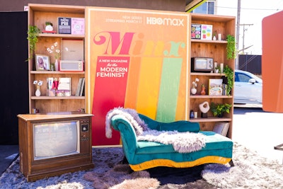 The backdrop was custom built and featured the fictional Minx magazine cover, accompanied by 9-foot-tall twin bookcases that were stocked with vintage books, records and ‘70s accouterments. Attendees could pose on a velvety chaise lounge or sit atop fluffy shag rugs. 3rdAve handled fabrication.