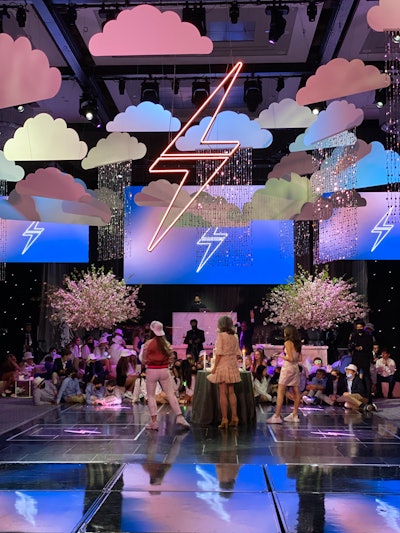 For its first post-pandemic event, David Stark Design in New York City fittingly outfitted the dance floor of the city’s Ziegfeld Ballroom in clouds “raining” shimmering beads and neon lightning bolts, symbolic of getting through the storm that was COVID-19.