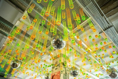 For a video game-themed mitzvah, Washington, D.C.-based Design Foundry created a ceiling-spanning “chandelier” out of slinkies and disco balls, proving that simple, everyday items can make a strong statement.