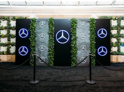 The Mercedes-Benz party’s step-and-repeat was designed with black metal panels, dimensional backlit logos in varying sizes and accented with panels of live greenery. Meanwhile, an interactive 10-foot Best Picture voting wall had a black marble effect with backlit dimensional Mercedes-Benz branding. Guests were able to vote for their personal selections using laser-etched, silver acrylic tokens. In addition to Sterling Social, the event featured decor and furnishings from R. Jack Balthazar, graphics and branding from Messex Industries, lighting design from Lighten Up, Inc. and fabric drapery from Revelry Event Designers.