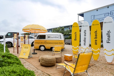 For its “Finally” campaign celebrating the return of in-person connections, Bumble and San Francisco-based Manifold decked out a corner of the Hamptons in Bumble-yellow beach chairs and a surfboard photo op with the slogan: “Beach make outs are back.”