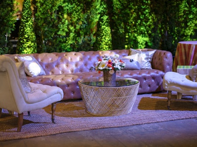 Lush green topiaries contrasted with colorful furniture vignettes where guests could sit and chat with other attendees.