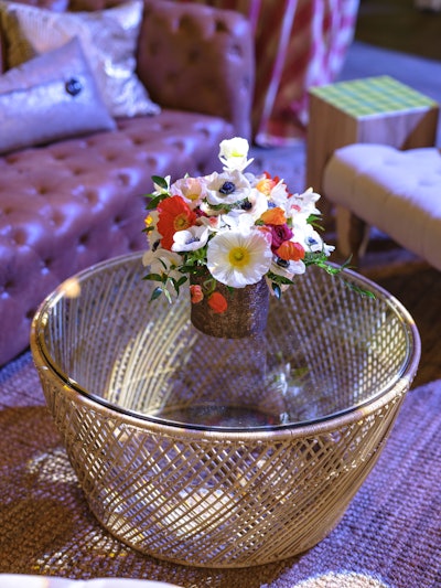 Blooms in the lounge area embraced the bright oranges, yellows and purples of spring. Duran Floral Design incorporated flowers like hellebore and ranunculus into the arrangements throughout the event.