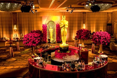 At ABC Television’s 2020 pre-Oscars party at the Four Seasons Los Angeles, Russell Harris Event Group handled design and production for the event, which oozed opulence. The North Hollywood-based event production and management company let the bar speak for itself, leaving bar branding to a single, larger-than-life Academy Award centering the expansive circular bar, which was adorned with four centerpiece-style rose bouquets in trophy-bronze vases courtesy of Los Angeles-based florist In Blume. All other event design elements merely served as supporting actors to the star: the bar. ABC Television, which aired the 93rd Academy Awards ceremony, tapped Lighten Up to handle the gold-hued lighting and Event Carpet Pros for the rich red and bronze-toned carpets that filled the entrance and main event room, respectively. See more: Oscars 2020: Steal-Worthy Event Design Ideas from the Week’s Most Stylish Parties