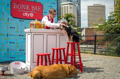 Who says bars are reserved for humans? Not CityTarget—the retail giant’s smaller-format stores—which outfitted a corner of Seattle’s Plymouth Pillars Dog Park into a paw-some “Bone Bar” back in 2012. Here, a “bonetender” handed out treats and toys to the city’s furry friends behind a white and black-outlined bar (reminiscent of a doodle on paper) with three Target-red stools, each a different height to accommodate dogs large and small. A bone-covered backdrop boasting “Bone Bar” written in the treat alongside CityTarget’s logo made for the perfect photo op. CityTarget tapped local full-service marketing agency Rally Marketing Group to develop the playful experience, which also included activities such as a tire jump and on-site portraits for pets and their humans created by a Seattle-based artist. The immersive, promotional event was a clever nod to Target’s mascot—a bull terrier named Bullseye. See more: 10 Best Ideas of the Week: Coca-Cola Pavilion at the Olympics, Pop-Tarts Pop-Up Concert, ‘Travel & Leisure’ Cocktail Wall