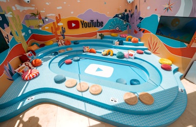 The YouTube Artist Lounge featured a fun seating area inspired by the YouTube logo—complete with bright and colorful pillows and desert-inspired wall decor.