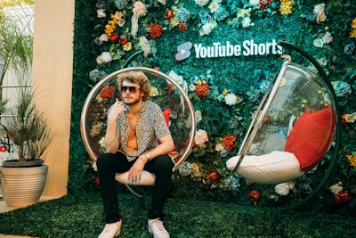 YouTube's Artist Lounge, produced by MAS, featured hanging bubble chairs in front of a floral- and greenery-covered backdrop.