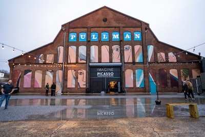 Pullman Yards is decked out in honor of Imagine Picasso. The facade is adorned with panes showcasing Picasso's Les Demoiselles d’Avignon.