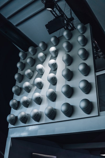 Decor at the pop-up was minimalist and luxe-looking. Take this helmet-covered wall installation, for example, featuring 36 monochromatic driving helmets.