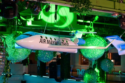 For Floyd Mayweather's birthday party, Los Angeles-based Wright Productions decked out a nightclub in 'Air Mayweather'-branded airplanes, which hung from the space's vaulted ceilings alongside crystal balls dripping in greenery.