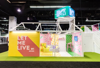 The MTV booth's living room area was covered in colorful patterns on the walls, floor, couch, books, TV, and plants, while a kitchen area was inspired by 2018 food trends like unicorn and mermaid toast. Cabinets were filled with MTV-branded cereal boxes, glittery slime bottles, Snooki pickle jars, and sand art. See more: VidCon 2018: 26 Colorful Ways Brands Targeted Generation Z