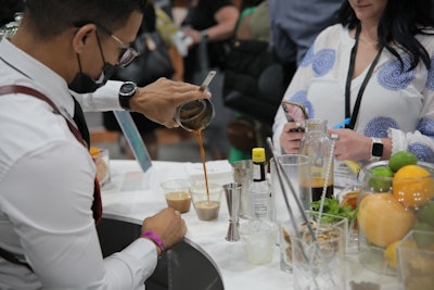 A bartender serves up espresso martinis at the Hubilo booth.