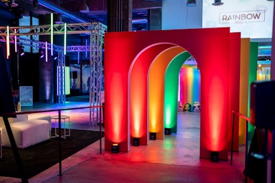 A series of large archways separated the two areas. From one side, the arches were lit in vibrant, rainbow-themed colors, while the other side was black, white, and gray. “Utilizing up-lights is hands-down one of the easiest and most effective ways to fill a space and make scenic builds more dynamic,” Stoelt advised. “Most modern LED uplight fixtures are wireless and are DMX controllable, adding another layer of customization.”