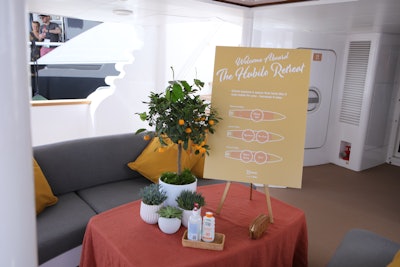 When guests first stepped on board, they were welcomed with a cool, lavender-scented towel to combat the over-80-degree days. And once on the yacht, a map of the three-level space and signage that said 'Come explore a space that feels like it was made for you—because it was' served as another greeting. Sunscreen and hand sanitizer were placed at the entrance and in various spots throughout the space. The BMF team noted that for a yacht-based activation, it’s crucial to address outdoor elements like wind and heat, and also to think through constraints like a limited kitchen and any bolted-down furniture. They resolved this by carefully thinking through the guest journey through the yacht’s floorplan, and using some cleverly placed custom design elements and signage to keep guests comfortable and informed.