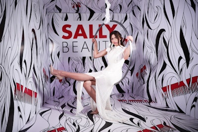 At the 2018 edition of Beautycon Media’s annual convention, retailer Sally Beauty had a carnival-themed booth complete with acrobat performers, games, and a miniature Ferris wheel of products. A branded photo backdrop featured illustrated black-and-white hair with red combs; guests sat in a spinning hoop to get their photos taken. The activation was designed and built by Conversate Collective. See more: 15 Ways Beautycon L.A. Helped Guests Get That Perfect Selfie