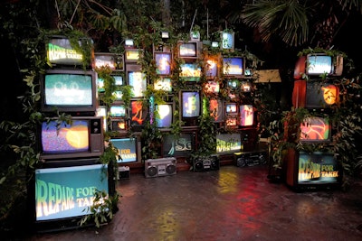 A wall of vintage TVs draped in greenery offered a fun, branded photo op.