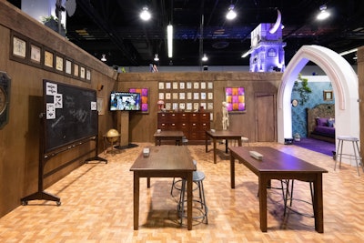 A wood-paneled classroom space included brand ambassadors posing as Monster High teachers. Guests were invited to take a quiz to determine which monster they most closely identified with, and were gifted a branded graduation sash in a particular color based on which monster their quiz revealed.