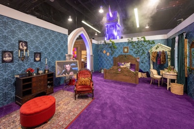 The school-inspired set featured a variety of rooms, including an interactive dorm room with three distinct areas for each of the three lead characters, featuring dozens of specialized decor and accessories, an oversized cauldron photo moment with fog, a selfie station with a vintage hair-styling chair, plus custom neon elements and wallpaper, and more. There was also a Grand Hall with 3D backlit windows, custom floor decals, school banners, and a gallery wall. A locker room featured functioning coffin-shaped lockers to house character-specific, themed elements, and a colorful, overhead pendant lighting and custom banners were also featured.