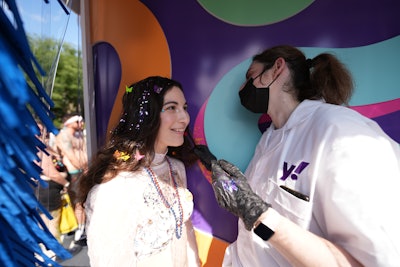 The design of the experience was inspired by nostalgic, throwback car wash elements such as shimmery plastic strip curtains, spinning buffers, and retro signage.