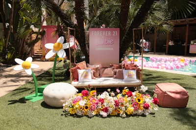 There were no shortage of photo-worthy moments on the 15,000-square-foot lot. Here, a pink-clad lounge seating arrangement featured Barbie pillows courtesy of Merch Industries, florals from Lovesome Blossoms, and a branded backdrop.