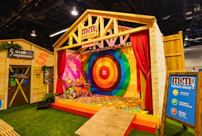 An M&M-branded stage hosted a fun talent show where attendees were invited to showcase their hidden talents, favorite dance moves, or air band skills. The activation was designed and executed by the experiences team at Conde Nast, with fabrication and build by 15/40 Productions.