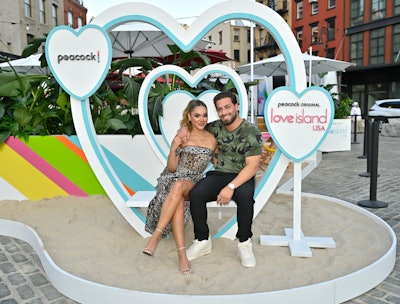 Cely Vazquez, Love Island USA season two runner-up, and UK Love Islander Kem Centinay stopped by the activation for a photo. But photos weren't the only things attendees could take to remember the event—in a fun touch to show fans some appreciation, Peacock partnered with Spotify so fans could save their favorite Love Island USA songs to a playlist.