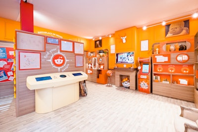 The main room, called The Den of Discovery, was a museum-like space highlighting interesting artifacts and moments from Reddit’s history, including framed printouts of iconic posts, a model build of a r/WallStreetBets rocketship, a photo op with the popular “This Is Fine” meme from the webcomic Gunshow, and even a faux bookshelf that opened for a 'rickroll' moment. Other highlights? The “Cartography Corner,” a product demo of Reddit’s keyword targeting capabilities, along with a custom arcade game where guests could test their knowledge of internet lingo.