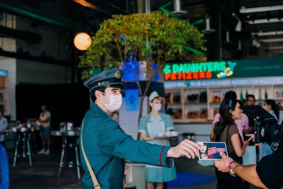 Upon entering, a costumed staffer greeted guests with a postcard welcoming them to 1960s New York City. As they explored the space, attendees were encouraged to get a stamp on their cards at each of the experience’s five stops. New York-inspired details included manhole covers, subway signs, and custom matchbooks.
