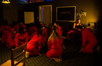 Participants were immersed in concepts from the show—from wearing red jumpsuits and Dali masks to being “held hostage” by the bad guys, and then solving puzzles and challenges in order to get out of the escape room. The challenge was to break into the vault and get the gold, just like in the show.