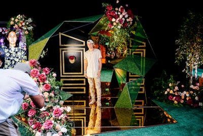 At the 10th edition of VidCon, held in July 2019, entertainment company Fullscreen worked with AKJOHNSTON Group to create an upscale, moody lounge featuring an overgrown foliage archway, an emerald green carpet, black draped walls, and crystal chandeliers. A geodesic photo moment incorporated gold mirrors and moss accents. See more: How VidCon Attracts 'the Most Media-Savvy Audience in the World'