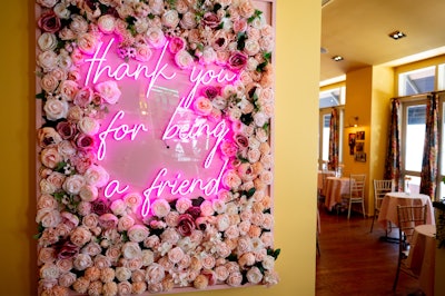 A pink neon sign advertises the show’s theme song, “Thank You for Being a Friend.”