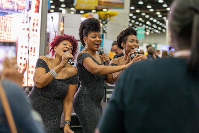 They don't call it Motown for nothing. One of the standout spots on the trade show floor this year? Visit Detroit's music lounge, where attendees heard from local acts against a backdrop slider showcasing some of Detroit's best scenery. Attendees especially loved this Marvelettes-inspired trio, who performed—among other hits—'Please Mr. Postman.'