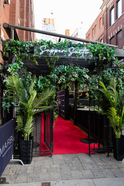 VIPs on the guest list were welcomed to the venue by a photo-worthy entryway overflowing with live greenery. Neon signage let attendees know they were at the right place before walking onto the red carpet and getting their picture taken in front of a branded step and repeat.