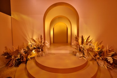 The event transformed the raw space into a posh tone-on-tone affair layered with shades of cream, champagne, and gold. Taking inspiration from interior design trends, the events team wanted to create an inviting space that felt both relaxed and opulent at the same time. These layered archways—created by Treehouse Fabrication & Scenic—proved to be a popular backdrop for many celebrities' photo ops. (Think: Ozark star and Emmys 2022 winner Julia Garner and the cast of Squid Game, to name a few.)