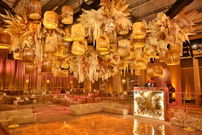 Inside, hanging above the dance floor, was a stunning lighting installation made of softly lit rattan pendants layered with floral clouds made of orchids, pampas grass, and dripping amaranthus designed by Floral Crush. (Consider our jaws dropped.) Lighten Up handled lighting. Dazian designed drapings.