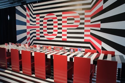At the 2016 edition of Dining by Design New York—a fund-raiser from Design Industries Foundation Fighting AIDS that showcases various dining settings and vignettes—Interior Design magazine worked with the late architect Ali Tayar, in collaboration with SilverLining Interiors, on this dramatic black, white, and red space. Thick, bold stripes displaying the word 'Hope' served as an eye-catching backdrop; the stripe effect continued to the table and floor.