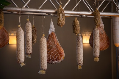 Dry-aged meats hung from a structure behind the charcuterie display and a Rusty Pelican chef crafted fresh mozzarella in real time.