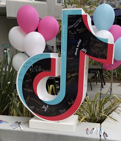 In a twist on a traditional yearbook signing, employees were invited to sign an oversized, 3D TikTok logo.
