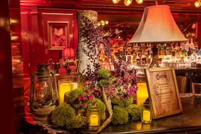 In what is surely a nod to the survivalist theme of Yellowjackets, a corner of the event's on-site bar was outfitted with forest-inspired accents and glowing candles. A wooden drink menu advertised show-inspired beverages playfully named 'Antler Queen' and 'Misty's Mushroom Tea.'