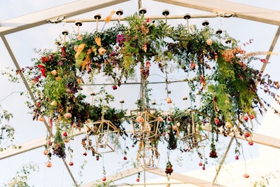 The trend of floral-filled, show-stopping lighting installations was also found at Disney's bash—this time made of inverted, suspended blooms. Amber Event Production designed lighting and chandeliers.