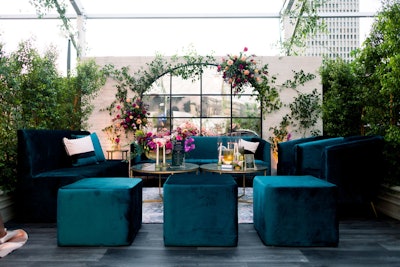 The French architecture motif extended to the luxe lounge areas inside The Greenhouse, where attendees could relax on furnishings in jewel tones like teal, emerald, and fuchsia.